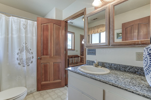 bathroom featuring tile patterned floors, visible vents, toilet, and vanity