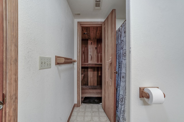 interior space featuring tile patterned floors, visible vents, and baseboards