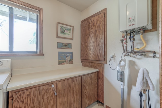 interior space featuring water heater and washer / dryer