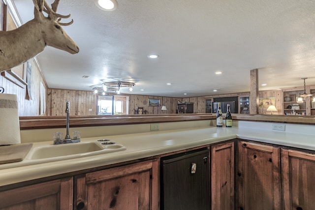 kitchen featuring recessed lighting, light countertops, and a sink