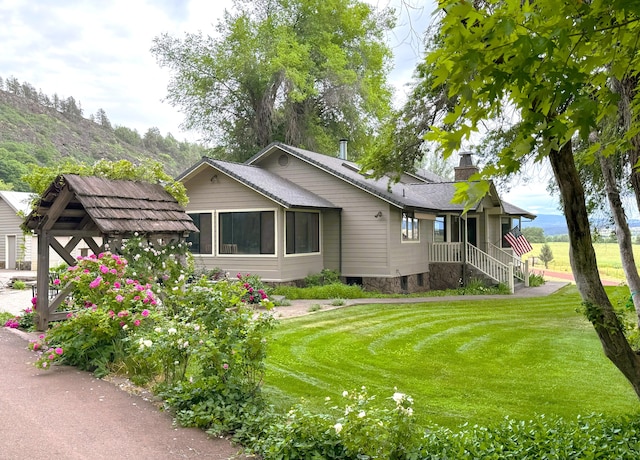 exterior space featuring a chimney and a front yard