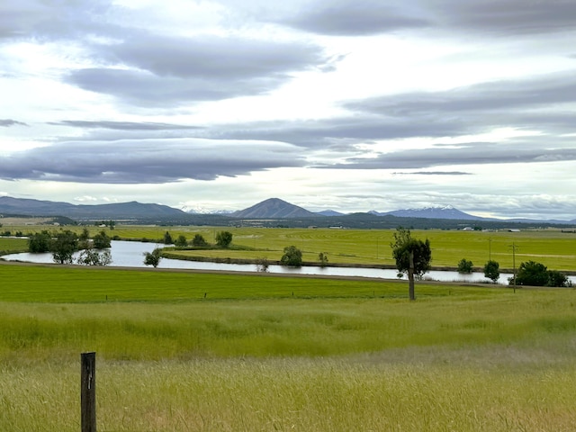 view of home's community featuring a water and mountain view and a rural view