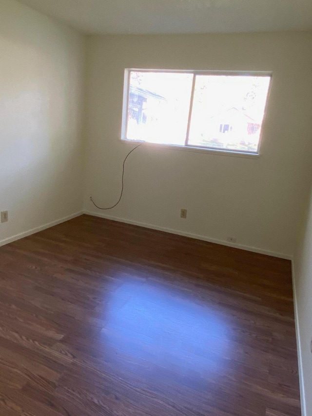 unfurnished room featuring dark hardwood / wood-style flooring