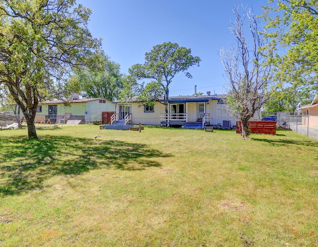 back of property featuring a yard