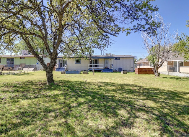 rear view of property with a yard