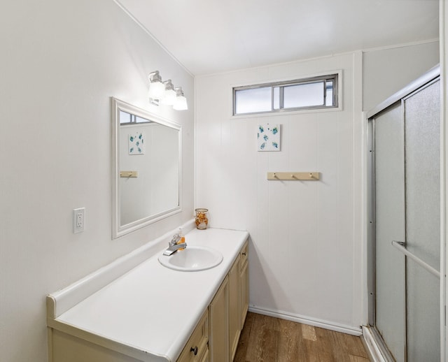 bathroom featuring hardwood / wood-style floors, vanity, and an enclosed shower