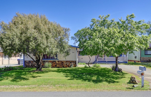 obstructed view of property featuring a front lawn