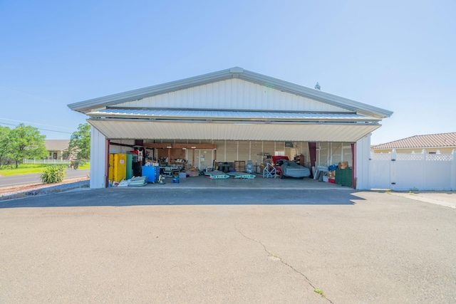 detached garage featuring fence