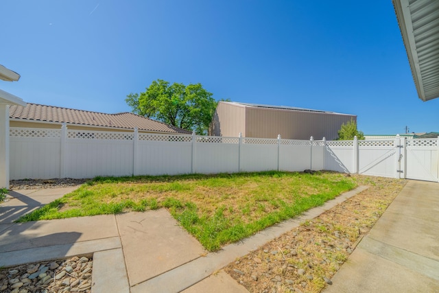 view of yard with fence and a gate