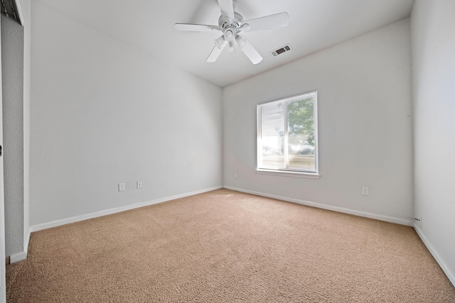 empty room featuring baseboards, a ceiling fan, visible vents, and light colored carpet