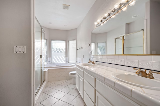 full bathroom with tile floors, oversized vanity, dual sinks, tasteful backsplash, and toilet