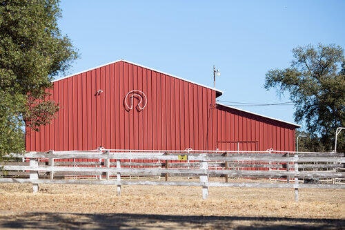 details featuring fence and an outbuilding