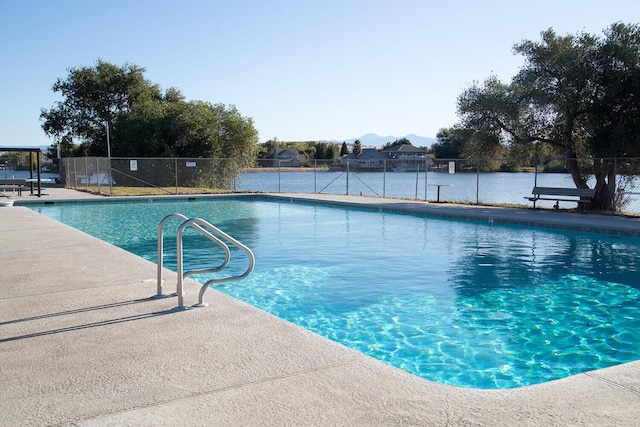 pool featuring fence and a patio