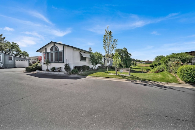 ranch-style home with a garage and a front lawn