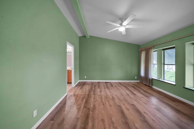 unfurnished room with lofted ceiling with beams, ceiling fan, and hardwood / wood-style flooring