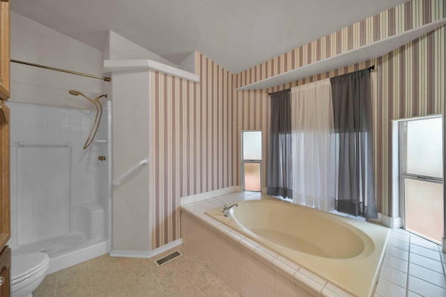 bathroom with tile floors, toilet, and separate shower and tub