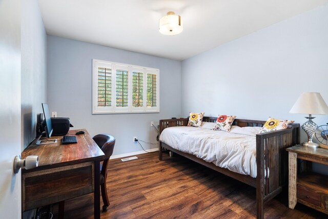 bedroom featuring dark hardwood / wood-style flooring