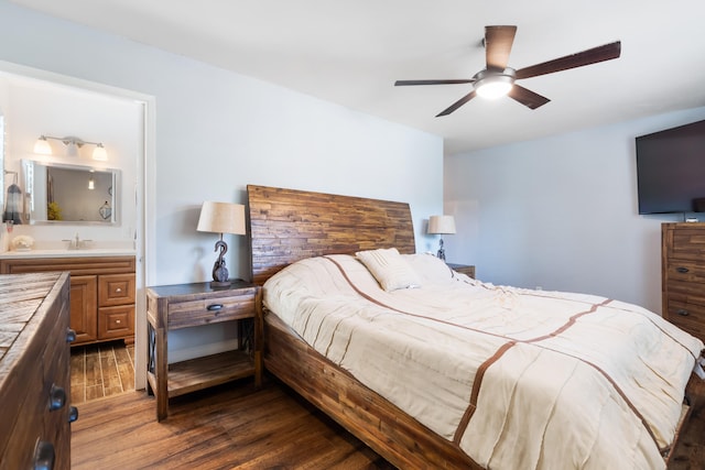 bedroom featuring ceiling fan, sink, hardwood / wood-style floors, and connected bathroom