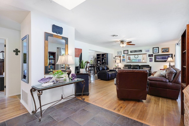 living room with ceiling fan and dark hardwood / wood-style floors