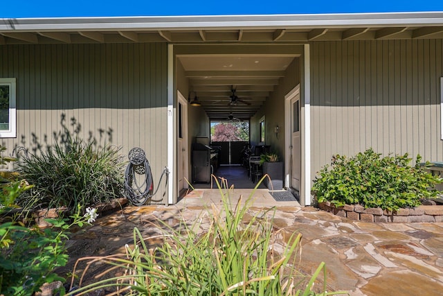 entrance to property with a patio and ceiling fan