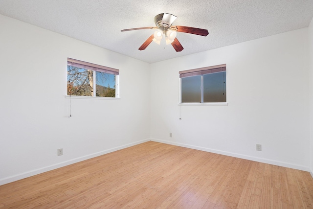 unfurnished room with a textured ceiling, light hardwood / wood-style floors, and ceiling fan