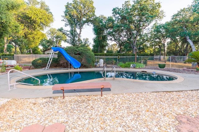 view of swimming pool featuring a patio area and a water slide