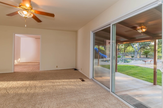 spare room with wood ceiling, carpet, and ceiling fan