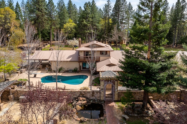 view of pool featuring a diving board and a patio area