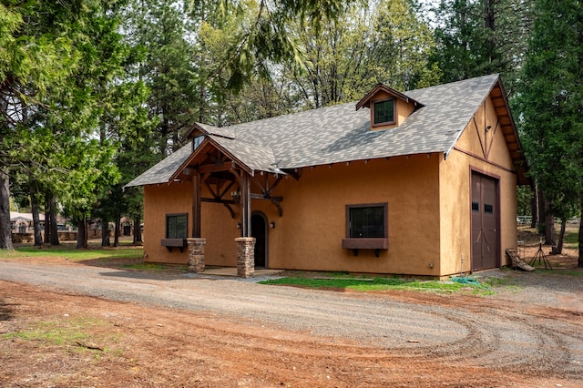 view of front of property with an outdoor structure and a garage