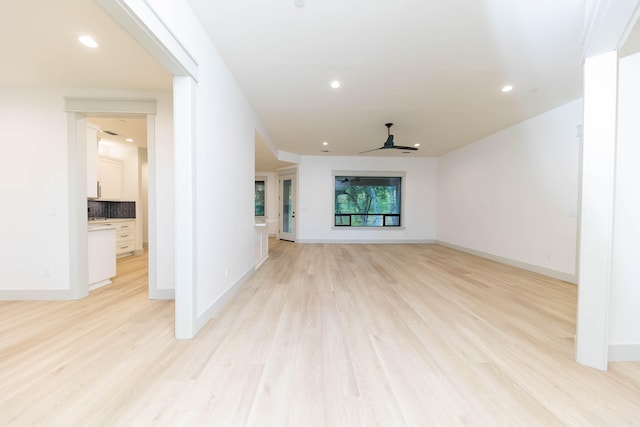 unfurnished living room with ceiling fan and light wood-type flooring