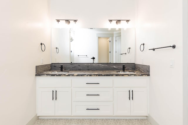 bathroom with dual bowl vanity and tile flooring