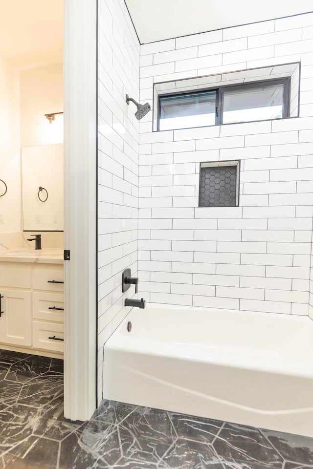 bathroom featuring tile flooring, tiled shower / bath, and vanity