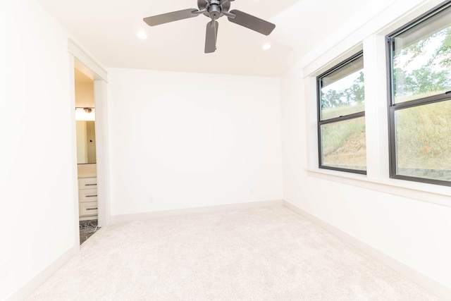 spare room featuring ceiling fan and carpet