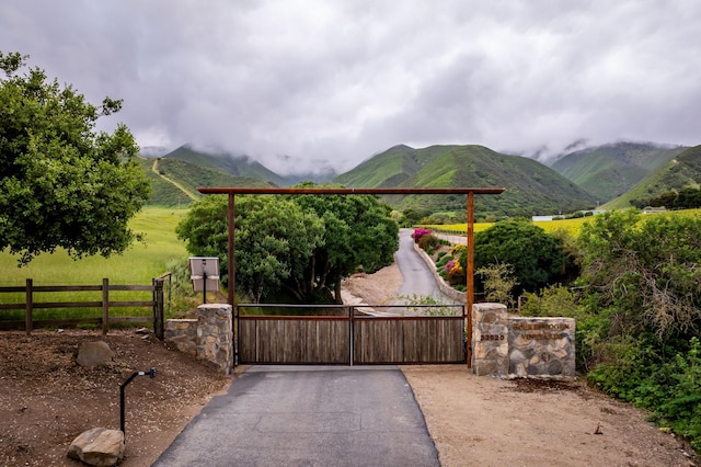 view of gate with a mountain view