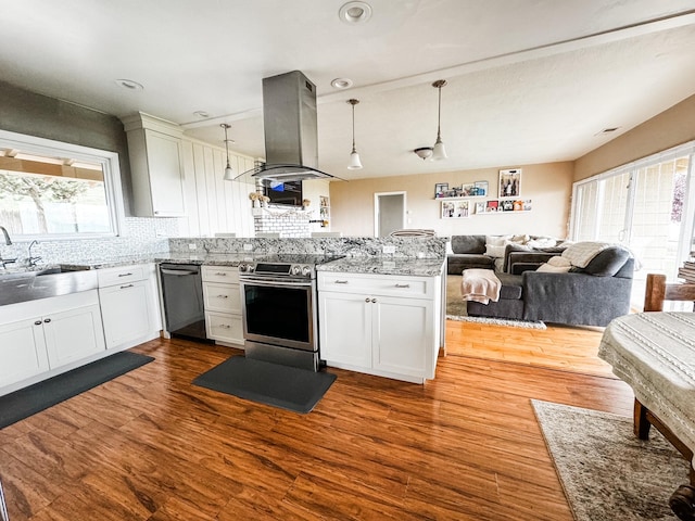 kitchen featuring decorative light fixtures, appliances with stainless steel finishes, island range hood, and a healthy amount of sunlight