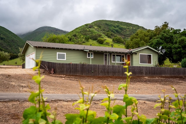 view of front of home featuring a garage and a mountain view