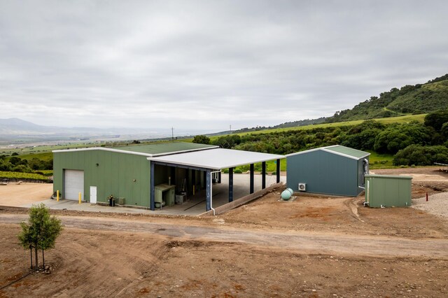 manufactured / mobile home with an outdoor structure, a carport, and a garage