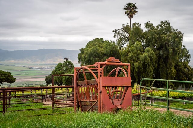 view of playground with a rural view and a mountain view