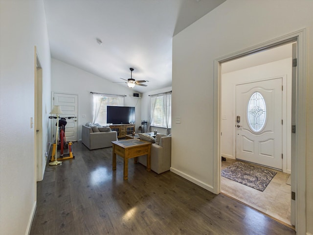 foyer with vaulted ceiling, dark hardwood / wood-style flooring, and ceiling fan