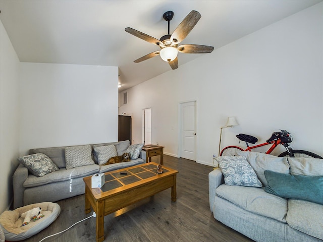 living room featuring dark wood-type flooring, ceiling fan, and vaulted ceiling