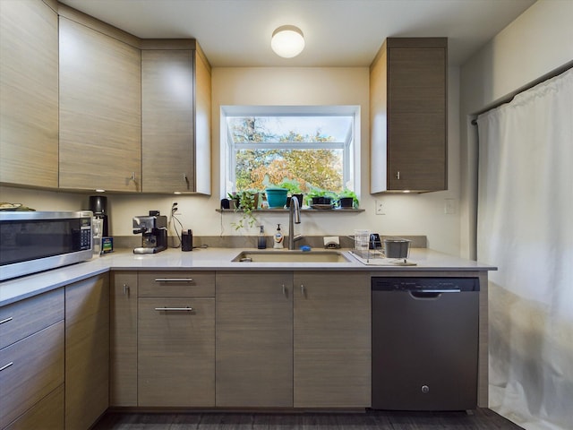 kitchen with sink, dark wood-type flooring, and appliances with stainless steel finishes