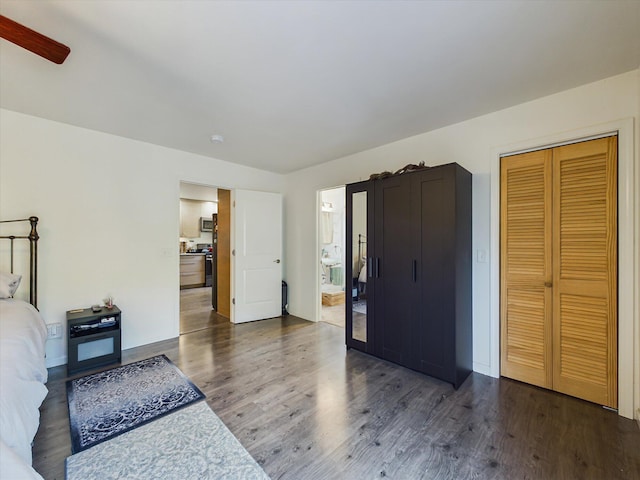 bedroom featuring dark wood-type flooring, a closet, and ceiling fan