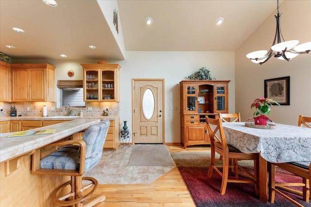 interior space with light hardwood / wood-style floors, sink, and an inviting chandelier