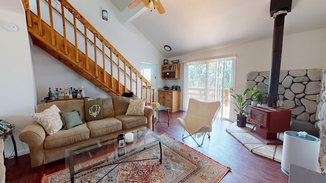 living room with high vaulted ceiling, hardwood / wood-style flooring, ceiling fan, and a wood stove