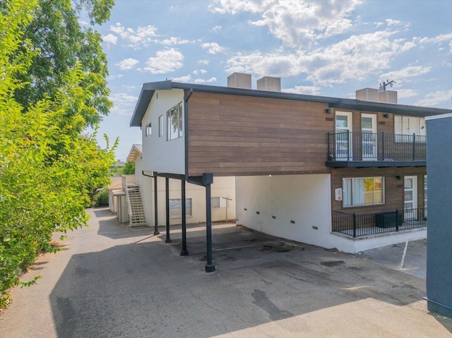 rear view of property featuring a balcony