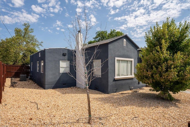 back of house with central AC unit