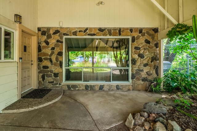 view of exterior entry featuring a patio