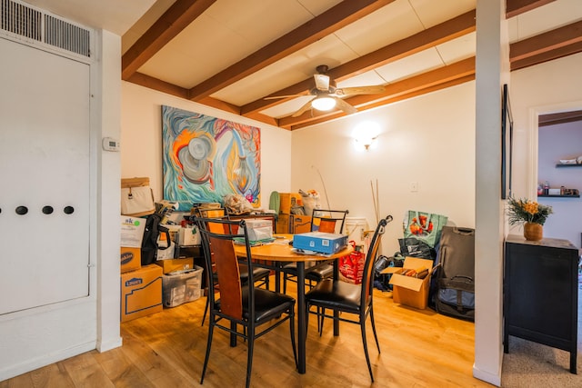 dining room featuring vaulted ceiling with beams, light hardwood / wood-style floors, and ceiling fan