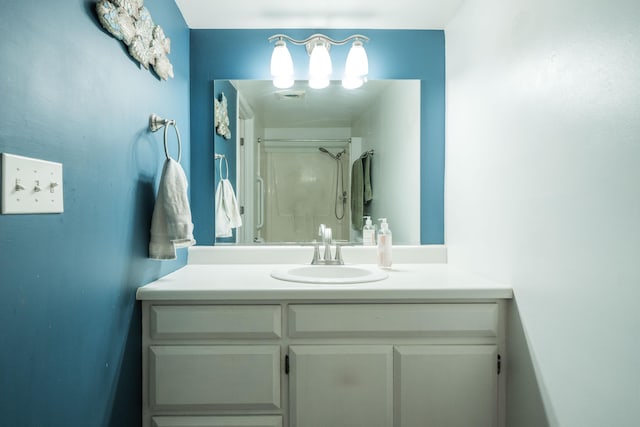 bathroom with a shower and vanity