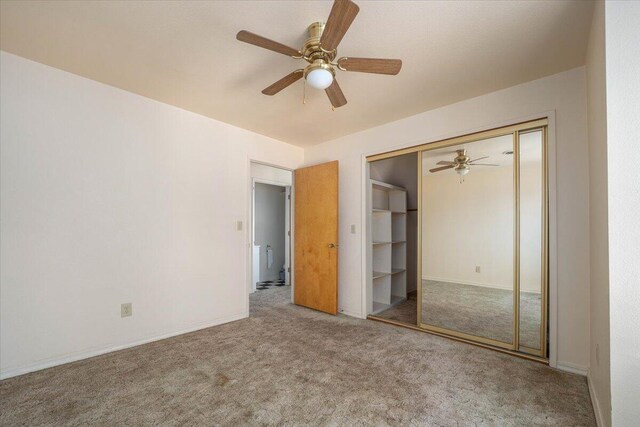 unfurnished bedroom with ceiling fan, carpet flooring, and a closet